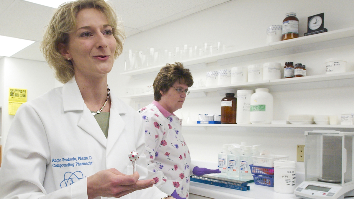 The Pew Charitable Trusts is urging states to tighten regulation of pharmacies that compound their own medication. Compounding pharmacist Angela Svoboda holds a nicotine lollipop used by those trying to quit smoking