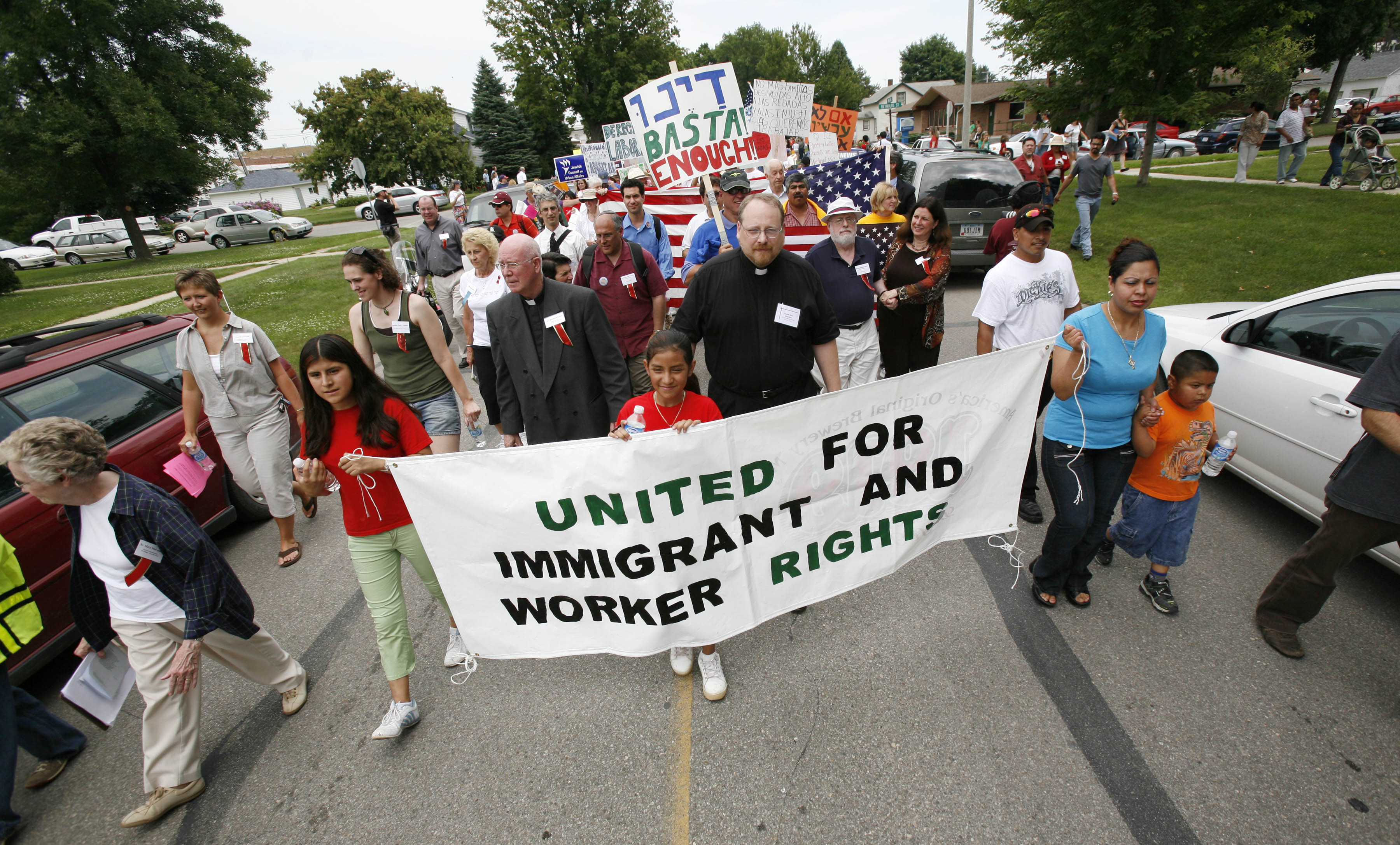 Hundreds of people march down a street