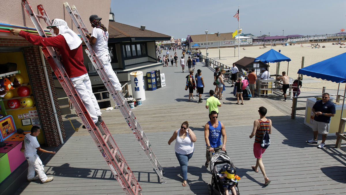 Workers put the finishing touches on fresh paint at an arcade on the boardwalk early Friday in Point Pleasant Beach
