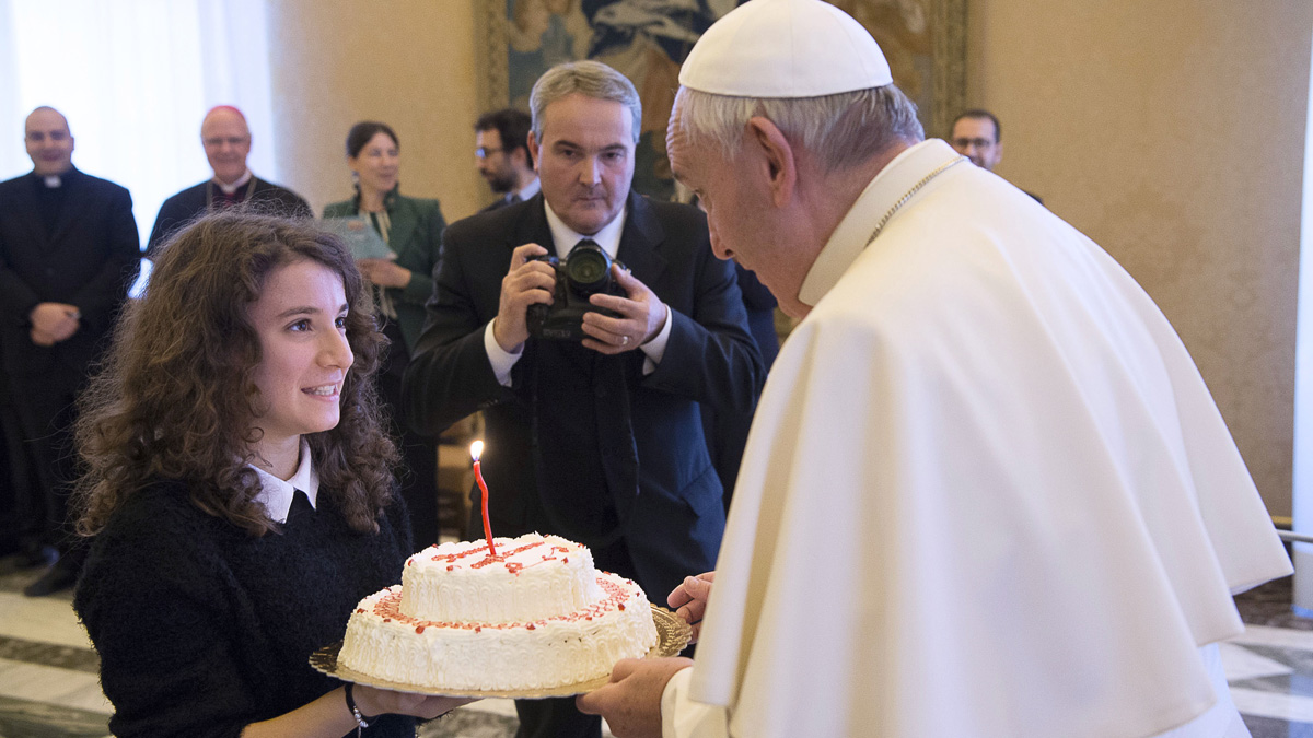  Pope Francis blows a candle on a birthday cake he was presented by a group of youths of the Catholic Action he received during a private audience at the Vatican Thursday. Pope Francis entered his 80th year on Thursday amid hopes among his critics that it will be his last — at least as pope. (L'Osservatore Romano/pool photo via AP) 