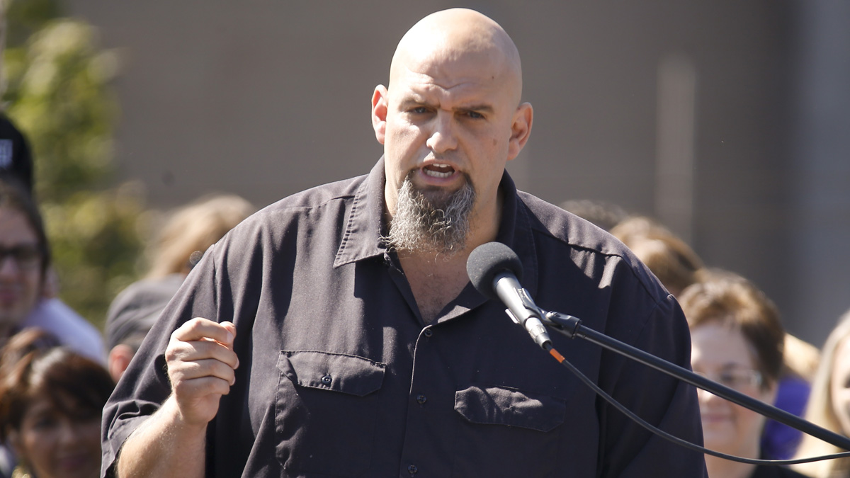 John Fetterman, the mayor of Braddock, Pa. addresses a crowd on the roof of his home during his announcement that he is running for the U.S. Senate on Monday, Sept. 14, 2015 in Braddock, Pa.(AP Photo/Keith Srakocic)