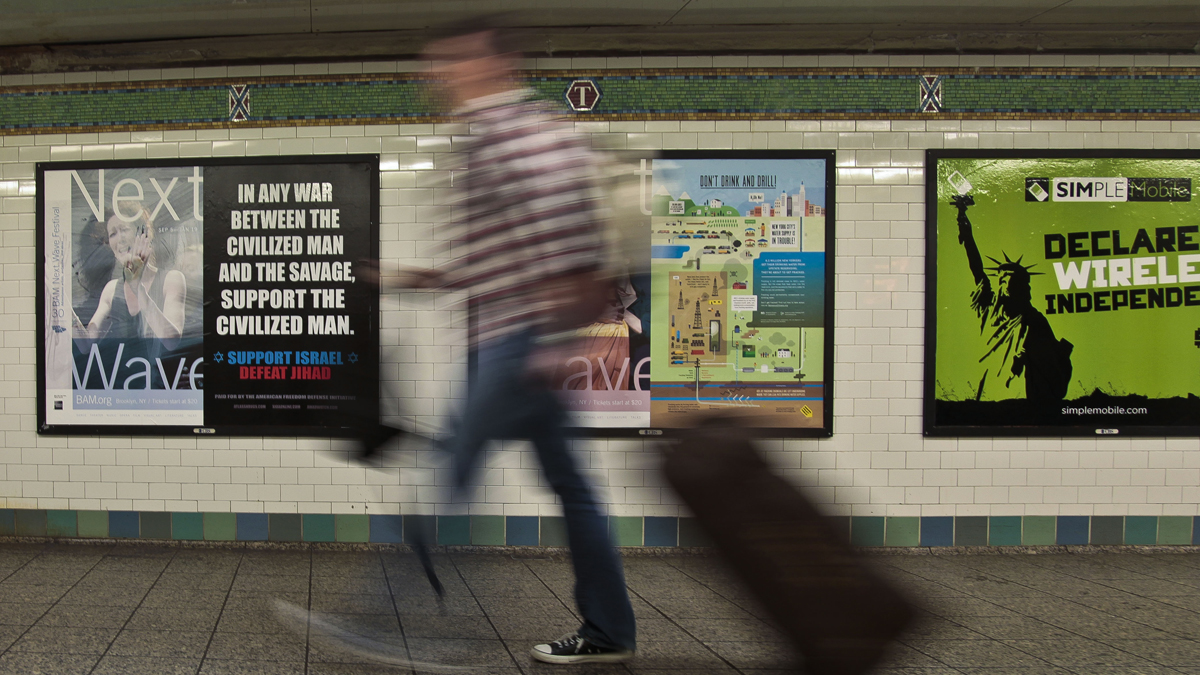  A commuter walks past an anti-Muslim poster in New York's Times Square subway station. The MTA initially refused to run the ad saying it was 'demeaning.' But a federal judge ruled that it is protected speech under the First Amendment of the U.S. Constitution. (Bebeto Matthews/AP Photo) 