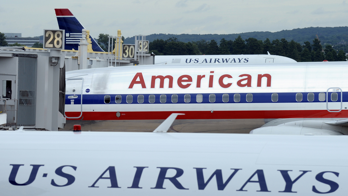  Several mayors, including Philadelphia Mayor Michael Nutter, have sent a letter to U.S. Attorney General Eric Holder urging that the Justice Department drop its opposition to the proposed $11 billion merger between US Airways Group Inc. and American Airlines' parent company, AMR Corp. (Susan Walsh/AP Photo, file) 