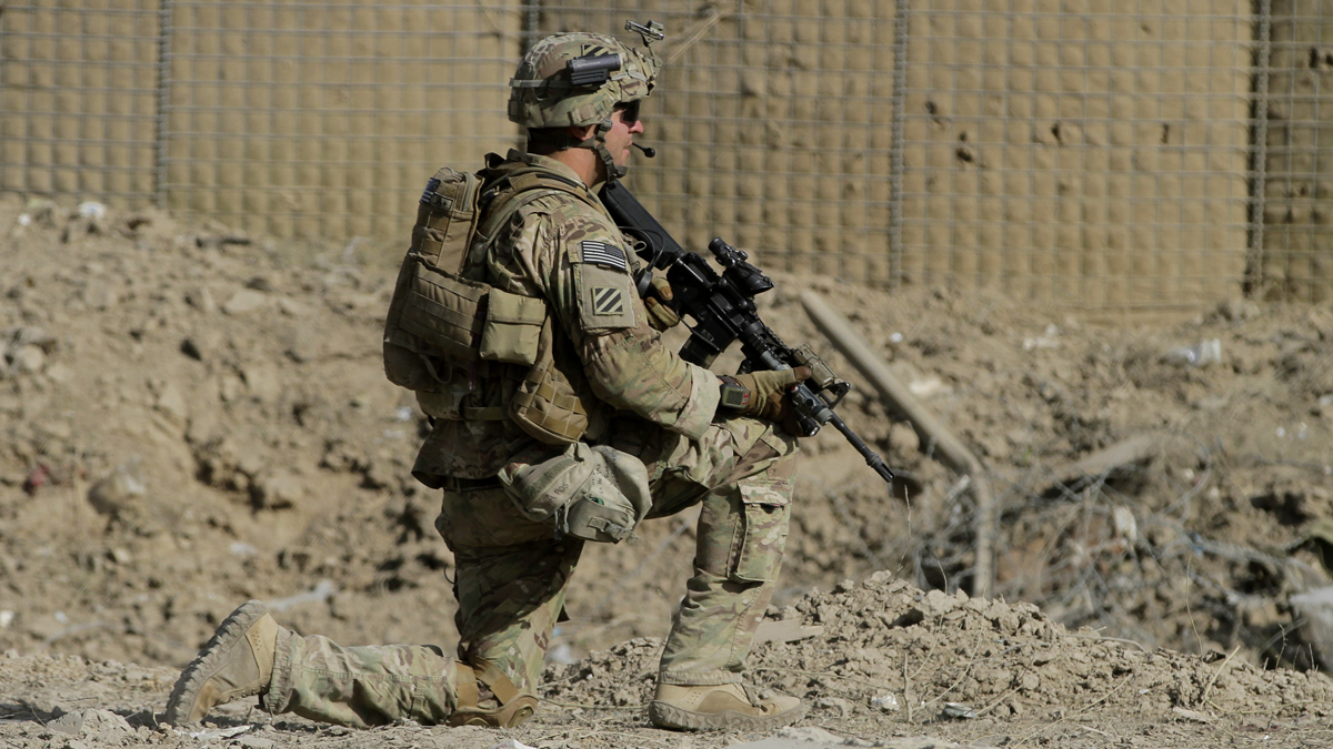  An American soldier, part of the NATO-led International Security Assistance Force (ISAF), kneels down at the site of a suicide attack in Wardak Province, east of Kabul, Afghanistan, Sunday, Sept. 8, 2013. Taliban militants detonated a car bomb outside an Afghan intelligence office near the capital Sunday and then tried to attack it on foot with guns, officials and the insurgent group said. At least four soldiers guarding the compound were killed and six insurgents died in the assault, officials said. (Ahmad Jamshid/AP Photo) 