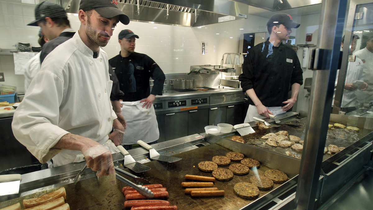  Aramark employees grill hotdogs, hamburgers and chicken. (Elise Amendola/AP Photo) 