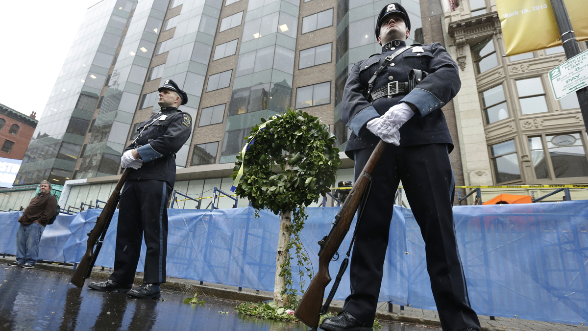  Ashland, Mass. police officers guard a memorial wreath at the site of the first bomb explosion near the finish line of the Boston Marathon, Tuesday, April 15, 2014, in Boston. Vice President Joe Biden attended ceremonies Tuesday to honor victims, first responders, and doctors and nurses who helped them, following the April 15, 2013 bombings, during a tribute in Boston. (Steven Senne/AP Photo) 