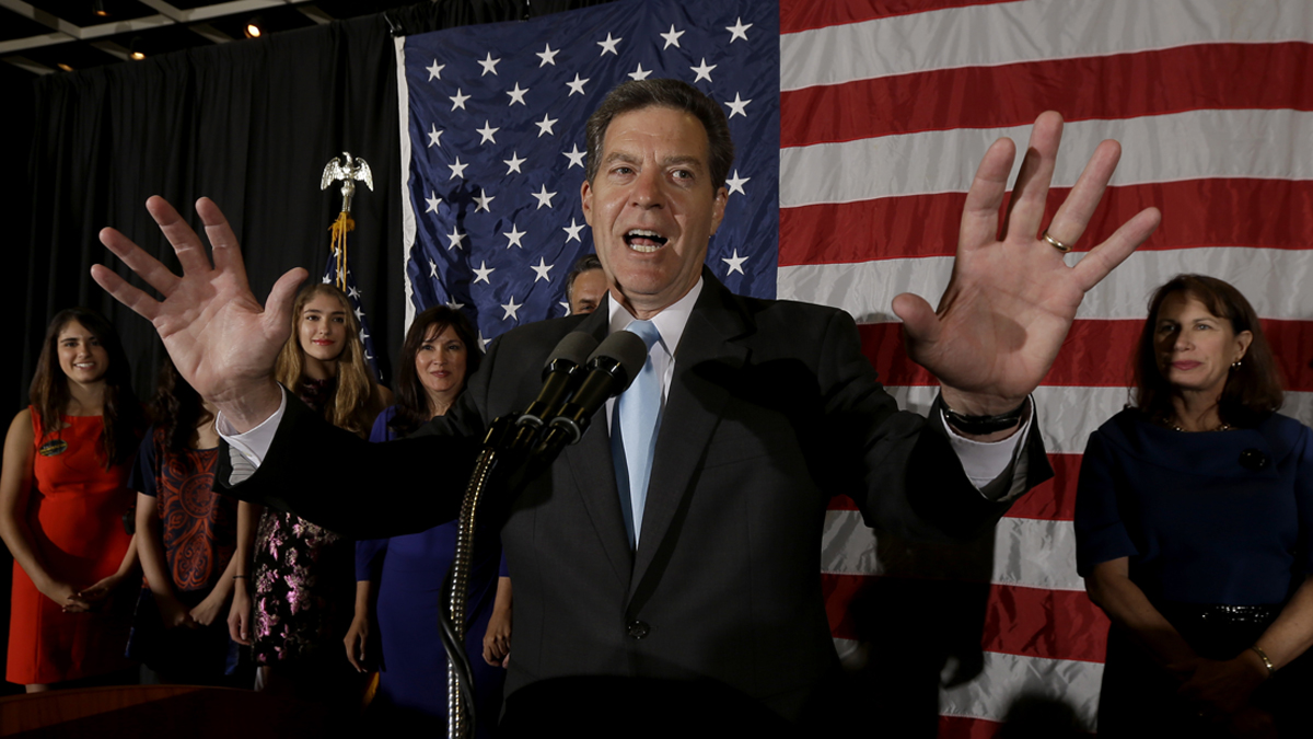  Kansas Gov. Sam Brownback makes his victory speech during a Republican watch party Tuesday, Nov. 4, 2014, in Topeka, Kan. (/Charlie Riedel/AP Photo) 