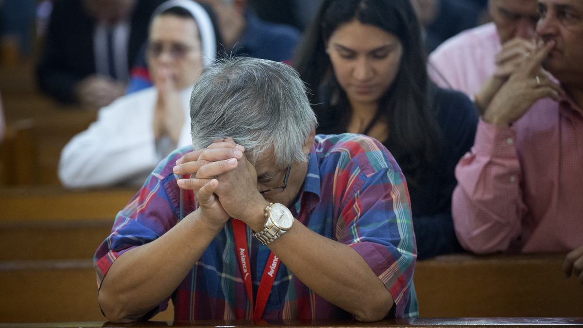 People pray as Archbishop Thomas Wenski used the annual Red Mass to discuss the Supreme Court hearing arguments regarding the U.S. Constitution requiring states to allow same-sex marriages