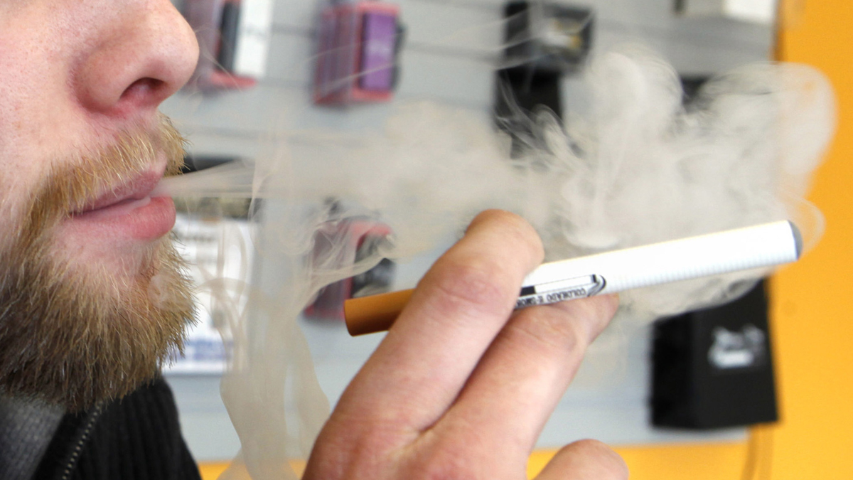  A sales associate demonstrates the use of a electronic cigarette and the smoke like vapor that comes from it in (Ed Andrieski/AP Photo, file) 