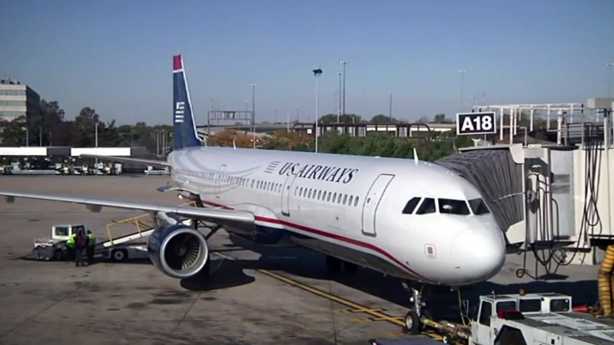  In this image taken from video, US Airways flight 1939, the final US Airways flight, prepares to depart Philadelphia International Airport for Charlotte, N.C. on Friday, Oct. 16, 2015. All future flights will fly under the American Airlines banner, following the completion of a merger announced in 2013. (AP Photo) 