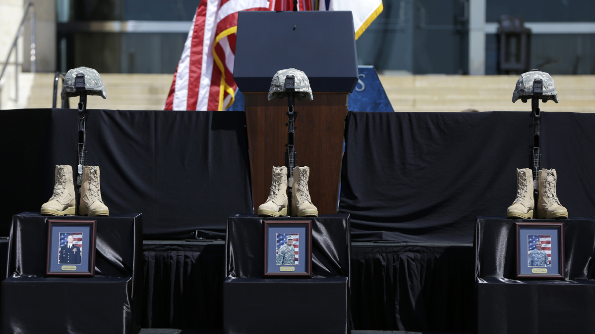  Three Soldiers Crosses for those killed in last week's Fort Hood shooting, from left, Sgt. Danny Ferguson of Mulberry, Fla., Carlos Lazaney-Rodriguez, of Aguadilla, Puerto Rico, and Sgt. Timothy Owens of Effingham, Ill, are set on the stage before a memorial service at Fort Hood, Texas. (Carolyn Kaster/AP Photo) 