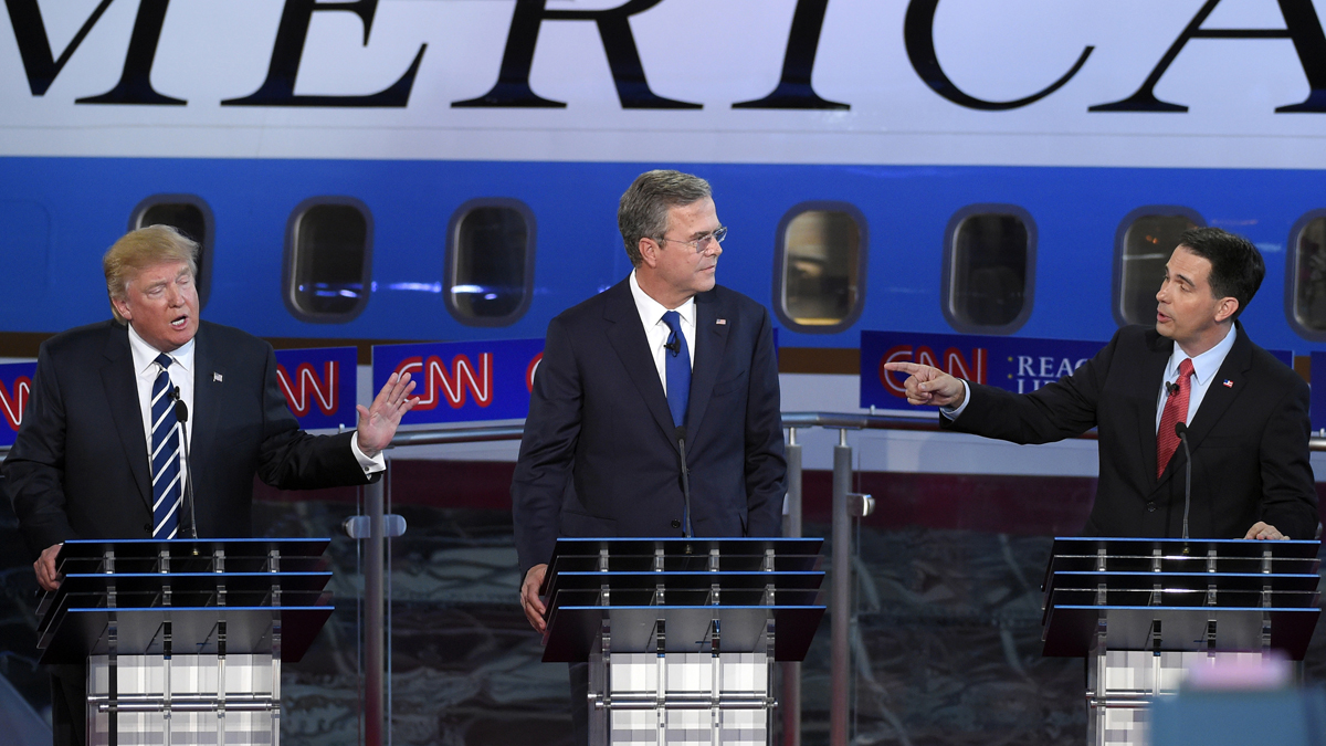  Republican presidential candidates businessman Donald Trump, (left), and Scott Walker, (right), both speak as Jeb Bush, listens during the CNN Republican presidential debate at the Ronald Reagan Presidential Library and Museum on Wednesday, Sept. 16, 2015, in Simi Valley, Calif. (Mark J. Terrill/AP Photo) 