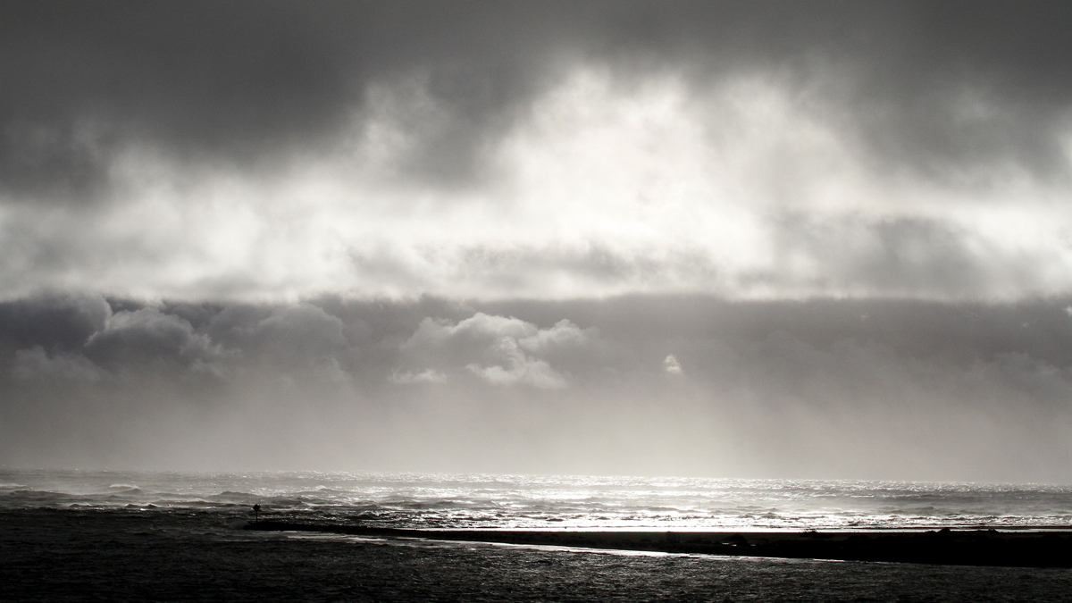 The sun breaks through the clouds over the Oregon Inlet near Nags Head