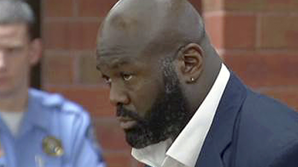   In this Oct. 21, 2013 file photo from video, former NFL defensive end and ex-ESPN analyst Hugh Douglas, center, stands with his attorney, Corey Brinson, right, during his arraignment in Superior Court in Hartford, Conn. Douglas is expected to plead no contest to a misdemeanor to resolve a case that accused him of assaulting his girlfriend at a Hartford hotel, his lawyer said Friday, Feb. 7, 2014. (Peter McCue/WFSB-TV, AP Photo, pool file) 