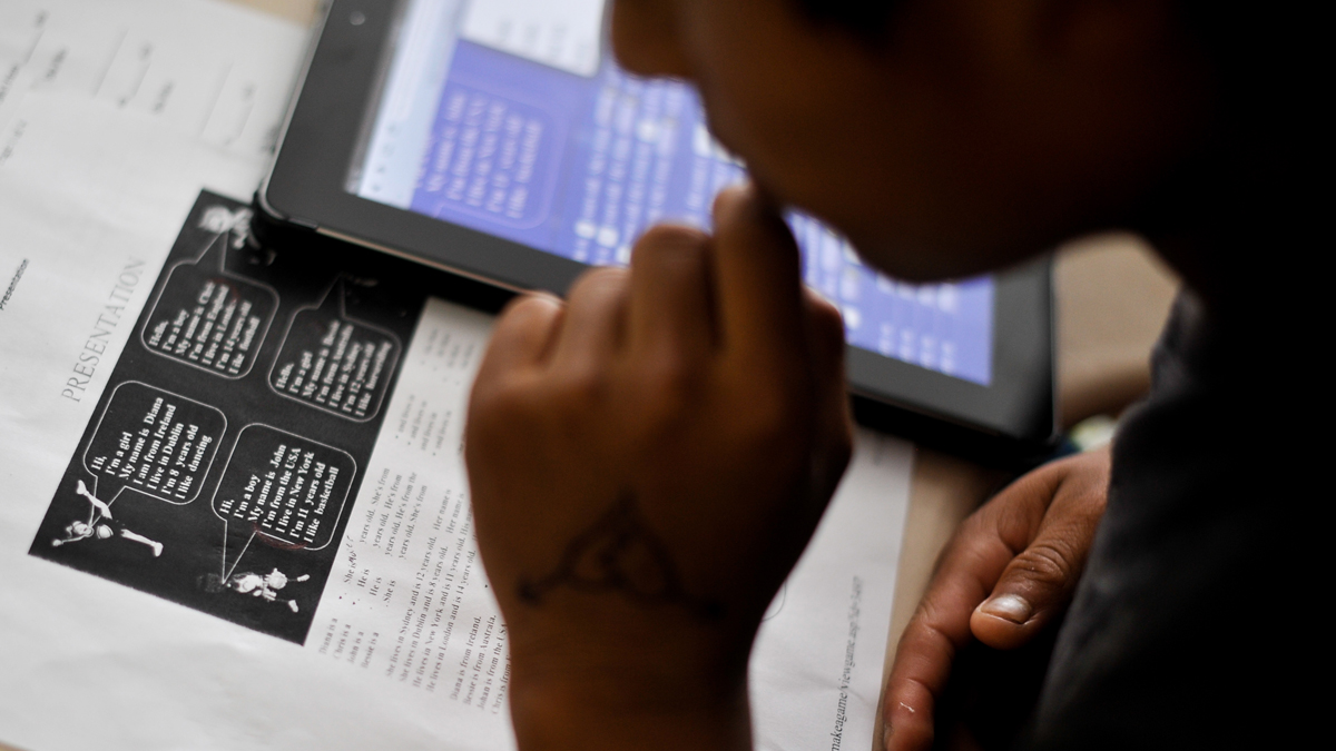 A student in the Accelerating Preliterate English Language Learners class looks over a worksheet aimed at teaching basic introductions in English. The Supreme Court has ruled that U.SA. schools have an obligation to educate all students regardless of their immigration status. (Emily Varisco/AP Photo)