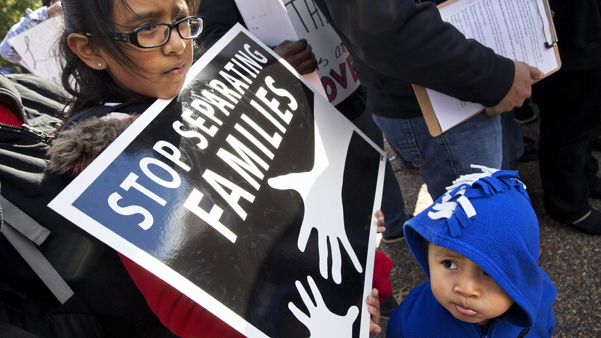  US citizens Esmeralda Tepetate, 10, with her brother Sebastian, 2, whose parents are originally from Mexico, holds a sign that says 'stop separating families' during a rally for comprehensive immigration reform, Friday, Nov. 7, 2014, outside of the White House in Washington. After the midterm elections immigration groups are pushing for executive action. (Jacquelyn Martin/AP Photo) 