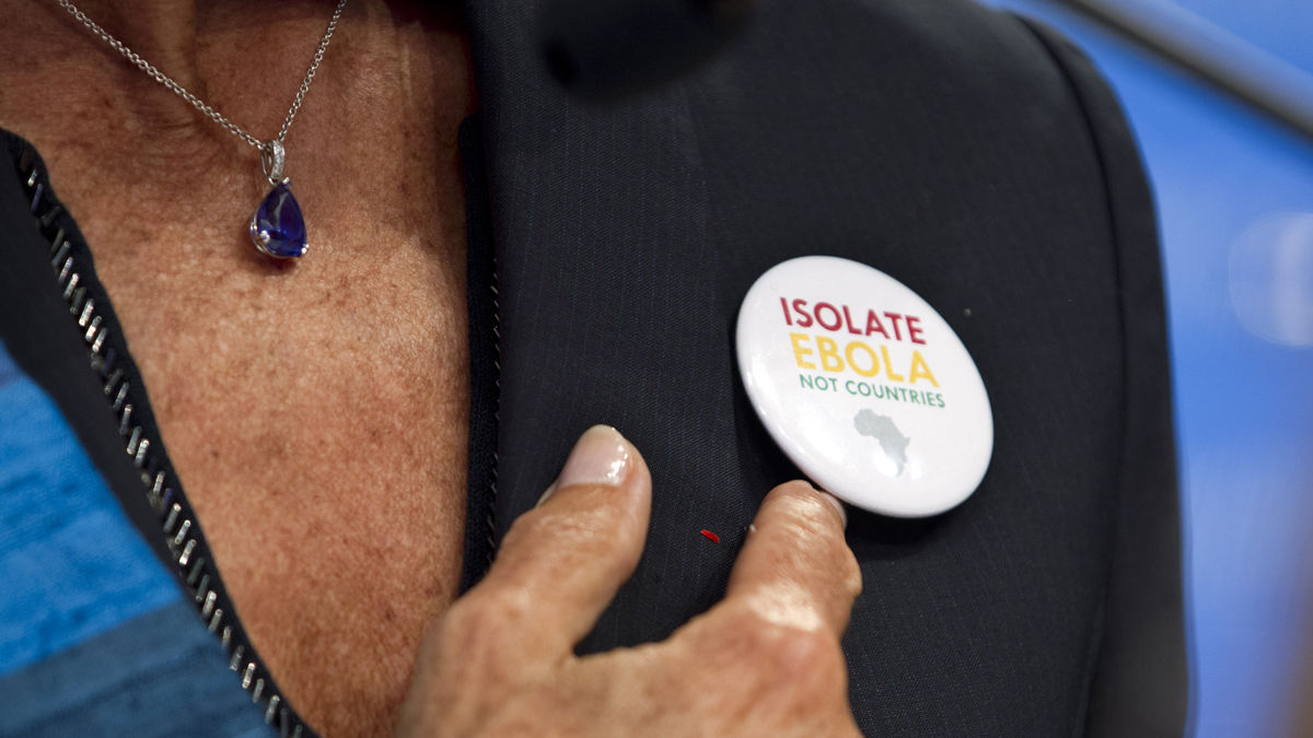  This photo shows International Monetary Fund Managing Director Christine Lagarde, pointing to the pin she's wearing in support of African countries fighting Ebola, as she speaks during a news conference at the World Bank Group-International Monetary Fund Annual Meetings at IMF headquarters in Washington, Saturday, Oct. 11, 2014. (Jose Luis Magana/AP Photo)  