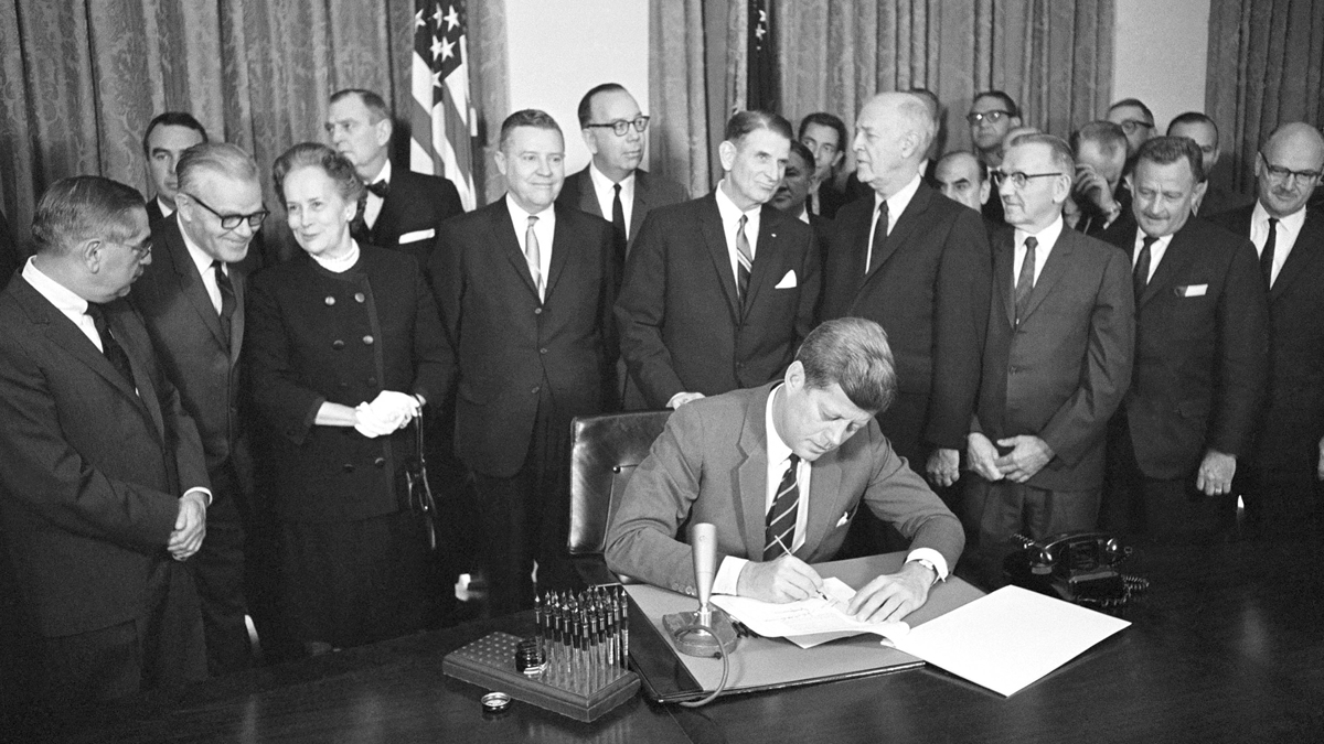  FILE - In this Oct. 31, 1963 file photo, President John F. Kennedy signs a bill authorizing $329 million for mental health programs at the White House in Washington. The Community Mental Health Act, the last legislation that Kennedy signed, aimed to build 1,500 mental health centers so those with mental illnesses could be treated while living at home, rather than being kept in state institutions. (Bill Allen/AP Photo, File) 