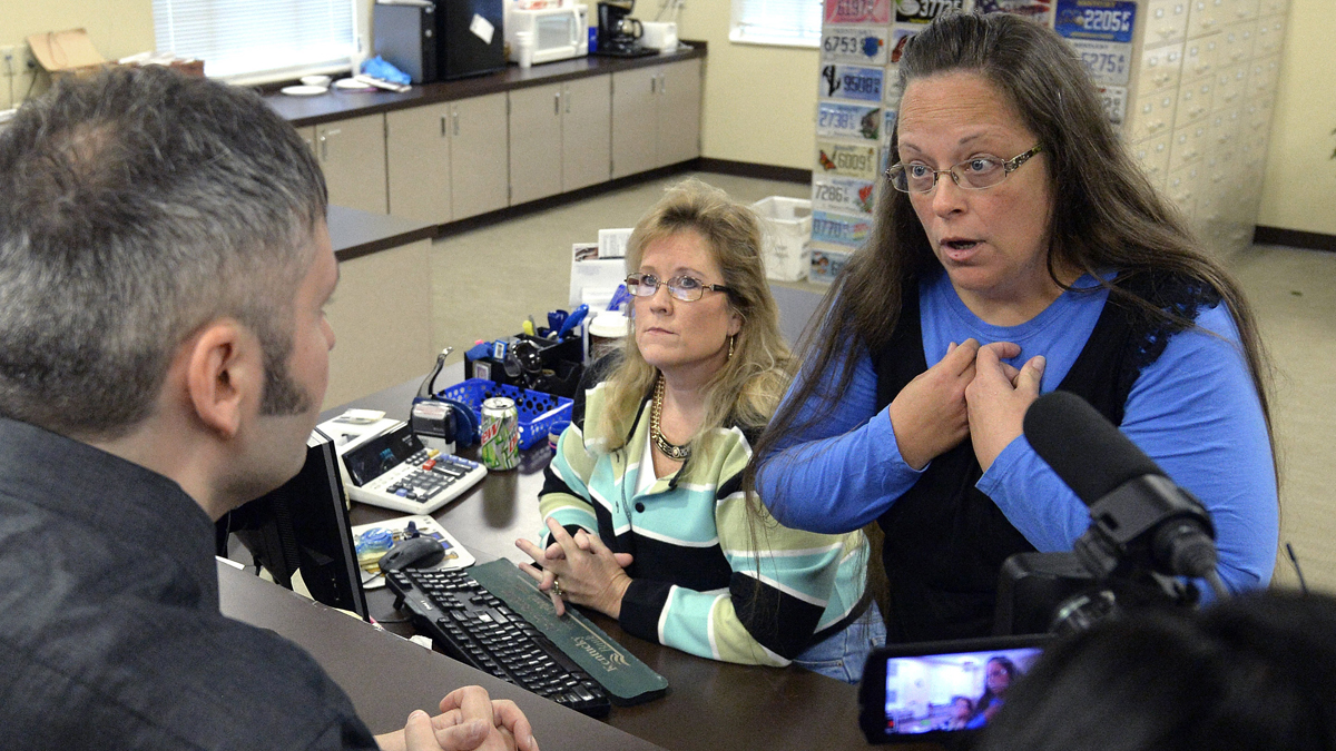  Rowan County Clerk Kim Davis, right, talks with David Moore following her office's refusal to issue marriage licenses at the Rowan County Courthouse in Morehead, Ky., Tuesday, Sept. 1, 2015. Although her appeal to the U.S. Supreme Court was denied, Davis still refuses to issue marriage licenses. (Timothy D. Easley/AP Photo) 