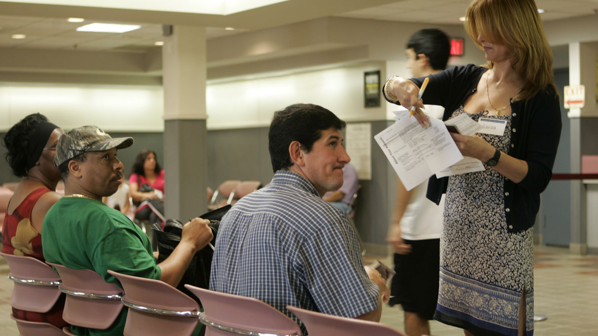 People wait at the Motor Vehicle Center in Wayne