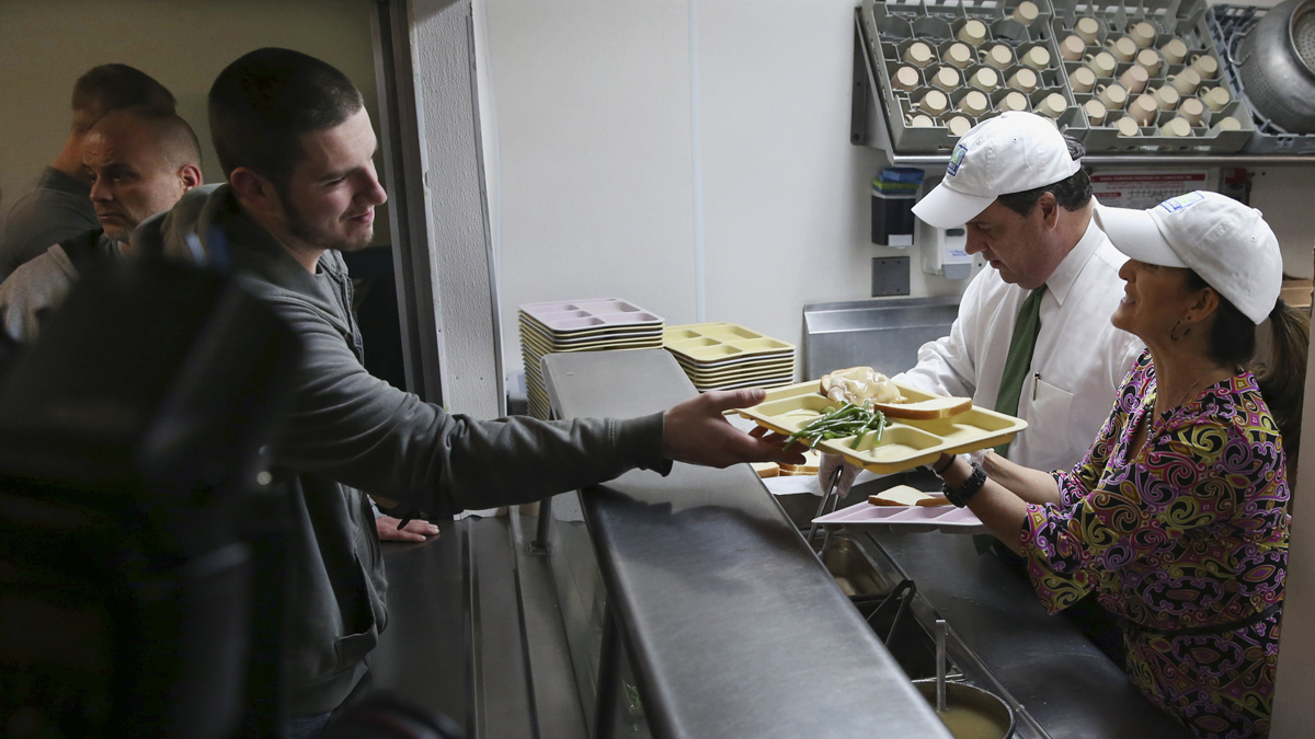  New Jersey Gov. Chris Christie and first lady Mary Pat Christie serve a luncheon meal to a gathering at the Market Street Mission Wednesday last month in Morristown, N.J. (Mel Evans/AP Photo) 