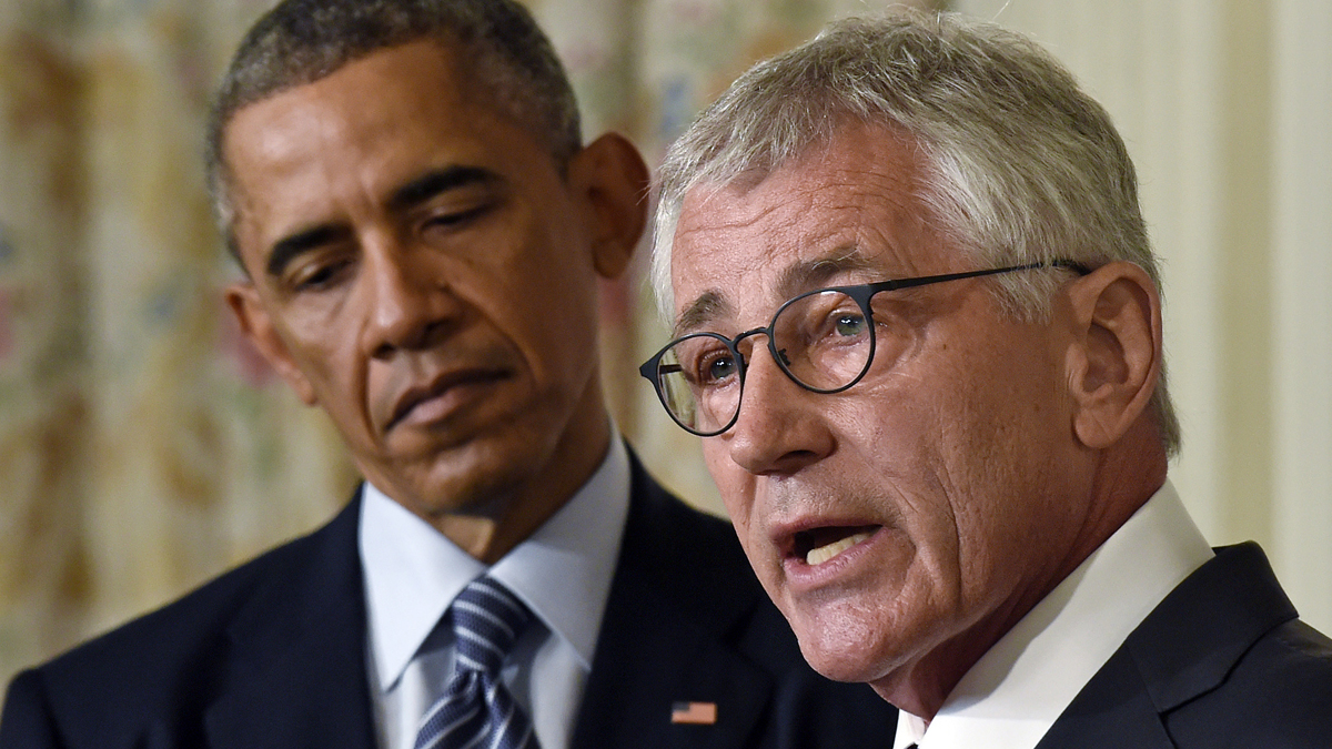  President Barack Obama listens as Defense Secretary Chuck Hagel talks about his resignation during an event in the State Dining Room of the White House in Washington, Monday, Nov. 24, 2014. Hagel is stepping down under pressure from Obama's Cabinet, senior administration officials said Monday, following a tenure in which he has struggled to break through the White House's insular foreign policy team. (Susan Walsh/AP Photo) 