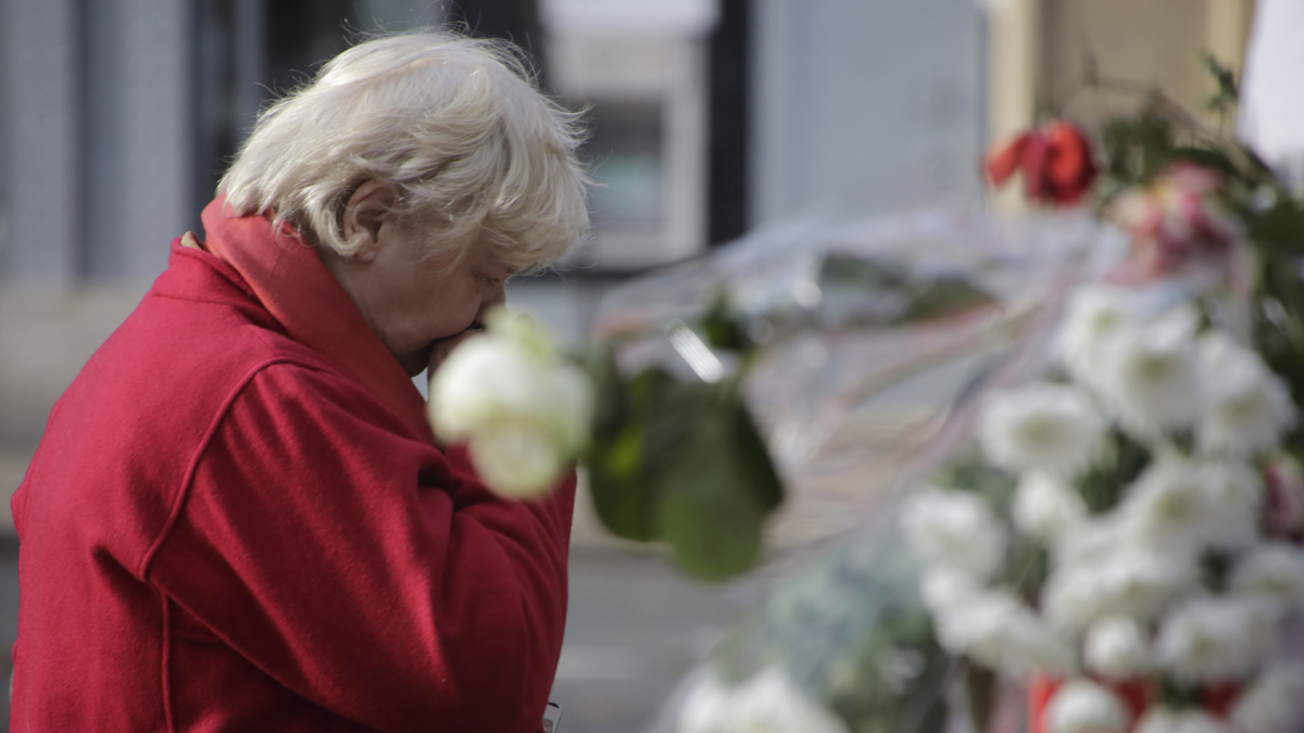  A woman pays her respects at a makeshift memorial next to the Bataclan concert hall in Paris Wednesday. (Amr Nabil/AP Photo) 