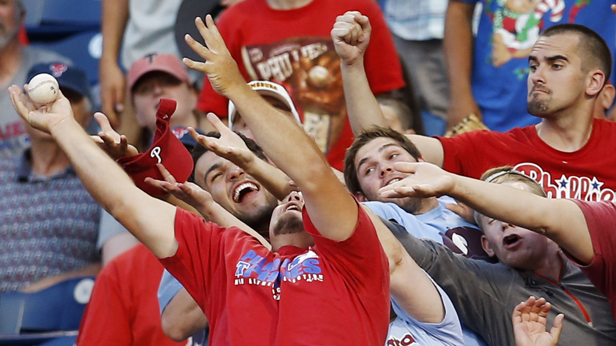  Fans reach for a foul ball hit by Philadelphia Phillies' Marlon Byrd during the third inning of a baseball game against the Miami Marlins, Tuesday, June 24, 2014, in Philadelphia. (Matt Slocum/AP Photo) 