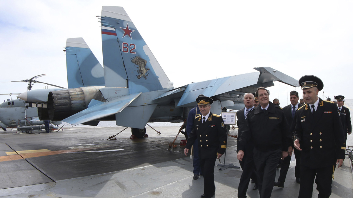  In this handout photo released from Cyprus Information Office, President of Cyprus Nicos Anastasiades, front second from right, walks with members of the Russian aircraft carrier “Admiral Kuznetsov” during his tour of the vessel outside of Limassol port south of Cyprus, Friday, Feb. 28, 2014. Anastasiades said Cyprus can act as a stabilizing factor in a tumultuous region because it’s uniquely positioned to offer its facilities to warships that engaged in enhancing regional peace and security. The aircraft carrier arrived in Cyprus Thursday for a three-day rest and resupply stay. (AP Photo/Press and Information Office) 