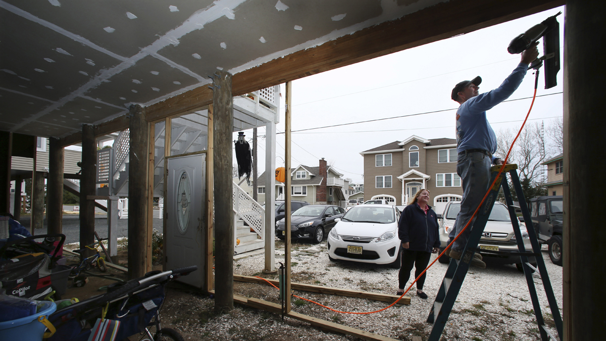  On Tuesday, while wife Dawn Markoski stands by, Stanley 'Sonny' Markoski works on their home that has been raised since being damaged, with about 27 inches of water in their house during Superstorm Sandy, in Long Beach Township, N.J. When FEMA announced that it would review Sandy-related claims to see if errors were made, the Markoskis submitted an application. The review concluded that they were owed an additional $55,972 in insurance money, nearly double what they had originally been paid. (Mel Evans/AP Photo) 