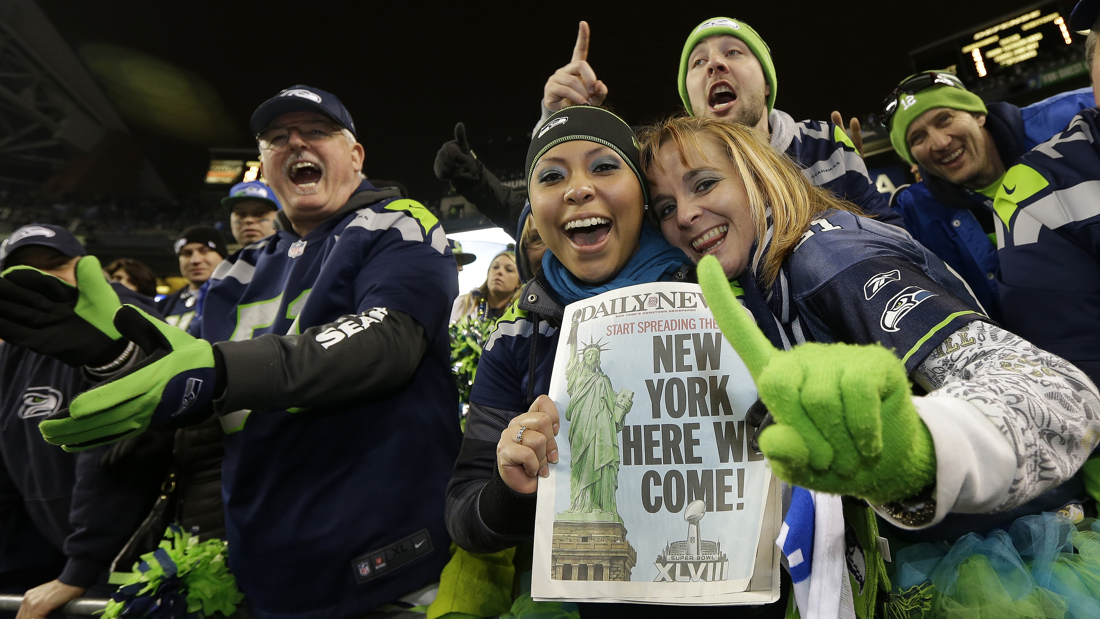  Seattle Seahawks fans celebrate after the NFL football NFC Championship game against the San Francisco 49ers Sunday, Jan. 19, 2014, in Seattle. The Seahawks won 23-17 to advance to Super Bowl XLVIII. (Ted S. Warren/AP Photo) 