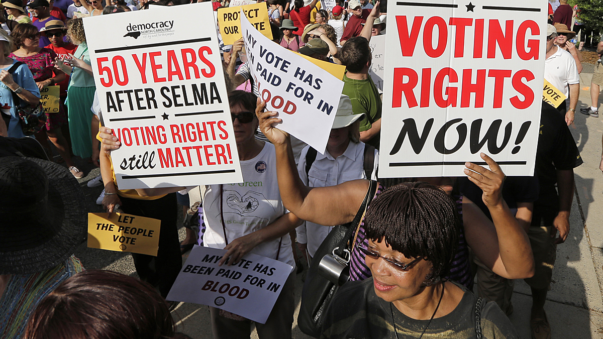 Demonstrators march through the streets of Winston-Salem, N.C., Monday, July 13, 2015, after the beginning of a federal voting rights trial challenging a 2013 state law. Election law experts say the case could determine how far Southern states can change voting rules after the nation's highest court struck down a portion of the federal Voting Rights Act just weeks before the North Carolina law was passed. (Chuck Burton/AP Photo) 