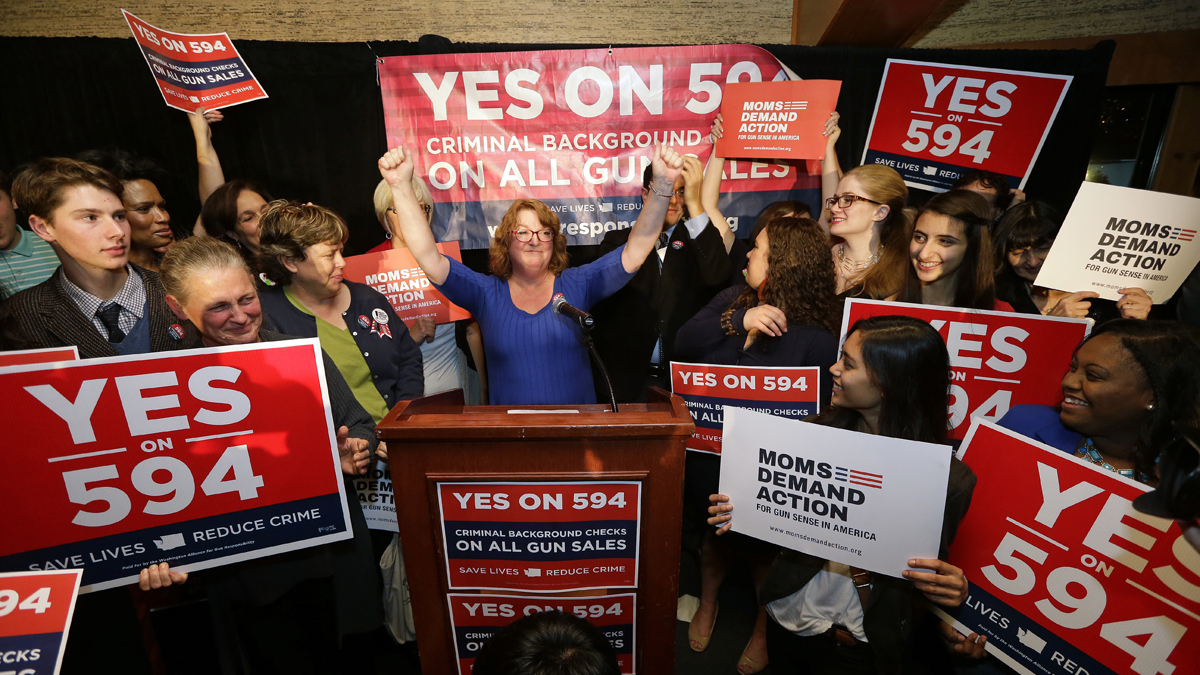  Cheryl Stumbo, (center) raises her arms as she finishes speaking at an election night party for Initiative 594, a measure seeking universal background checks on gun sales and transfers, Tuesday, Nov. 4, 2014, in Seattle. Stumbo, the citizen sponsor of the initiative, is a survivor in the shooting at the Jewish Federation in Seattle in 2006. The initiative is one of two competing gun initiatives in Washington state. The other measure, Initiative 591, would prevent any such expansion of background checks. (Elaine Thompson/AP Photo) 
