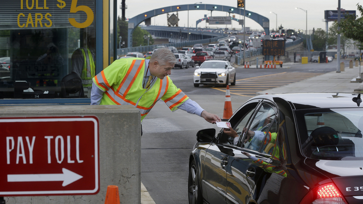  In May, Delaware River Port Authority CEO John Hanson, hands information cards to drivers in Camden at the toll lanes of the Benjamin Franklin Bridge between Camden and Philadelphia. The second phase of the PATCO train track replacement project over the bridge is set to begin this week. (AP Photo, file) 