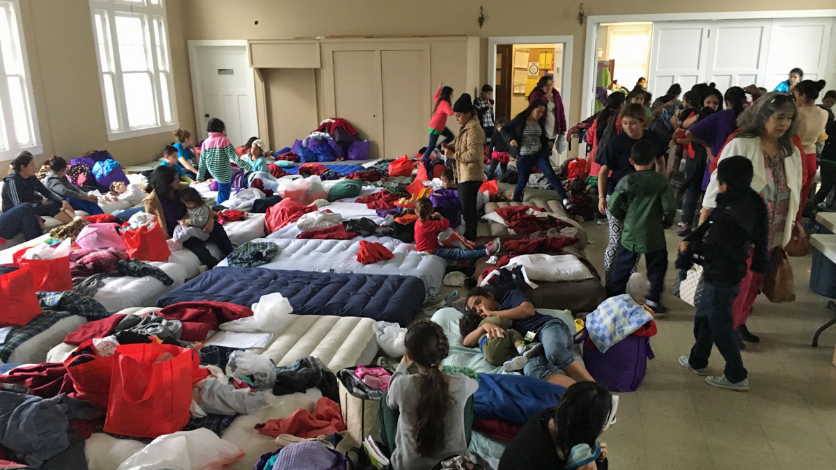 Families recently released from immigrant detention centers in Texas crowd a San Antonio church. (Joey Palacios/Texas Public Radio)