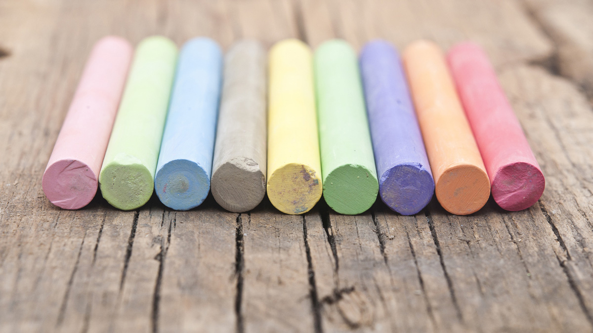 (<a href='http://www.bigstockphoto.com/image-53224528/stock-photo-colorful-chalks-on-old-wooden-table'>Big Stock</a>)