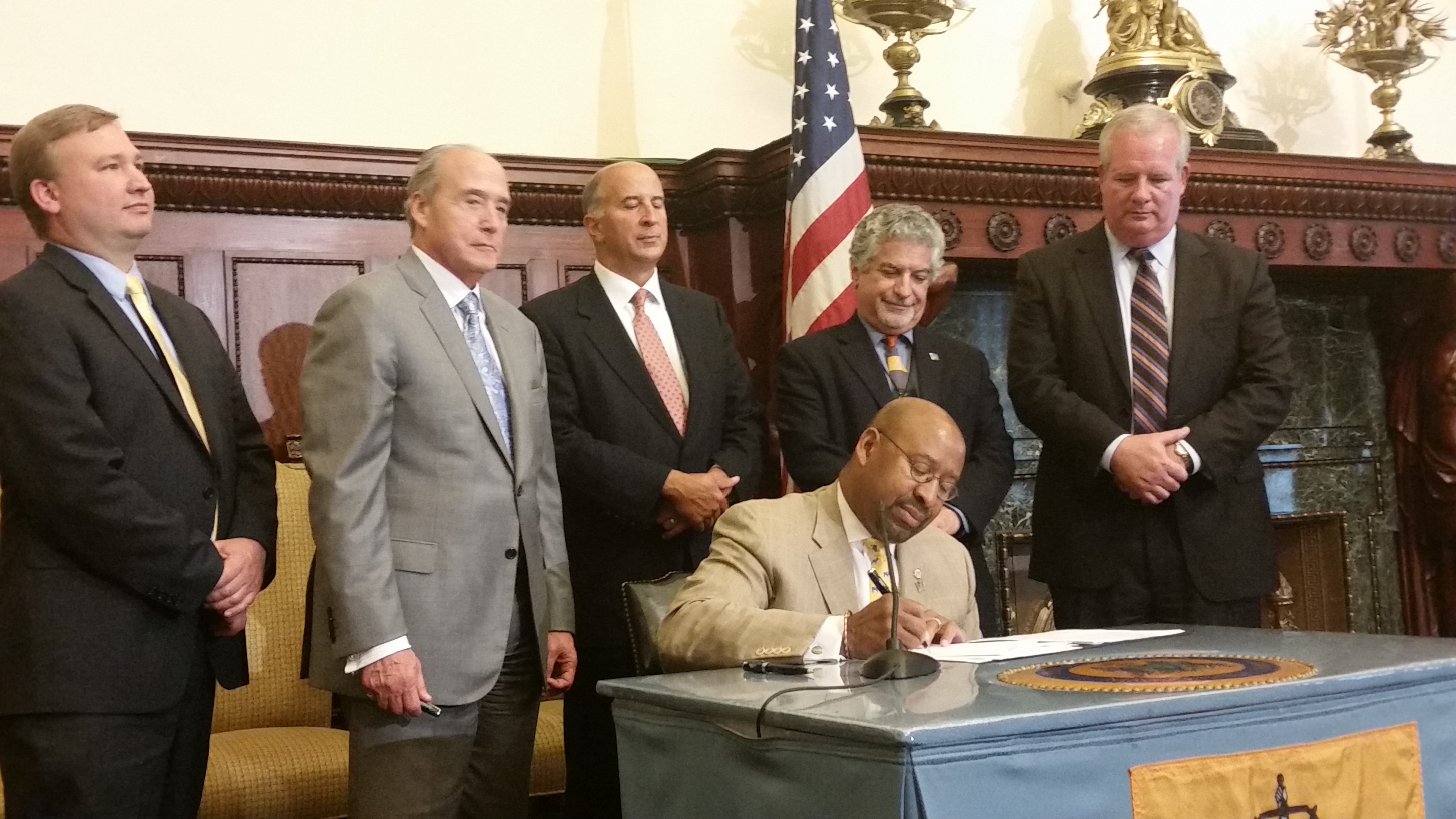  Mayor Michael Nutter signs the tax-increment financing deal to pave the way for redevelopment of the former Gallery Mall. The new mall is expected to generate 1,000 jobs when it's finished in two to three years. (Tom MacDonald/WHYY) 