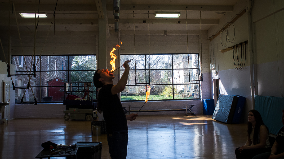 David Darwin demonstrates fire eating at a class on side show performance at the School of Circus Arts in Germantown. (Brad Larrison/for NewsWorks)