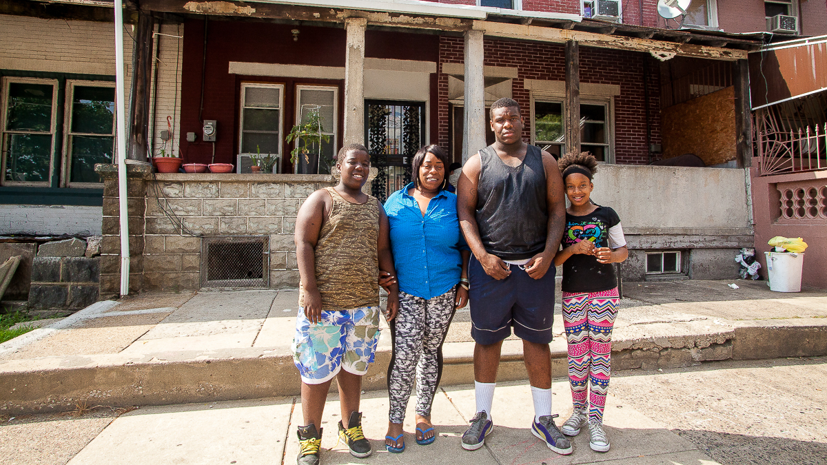  Dawayne Young stands with his mother Annette Thomas, sister Daniyah and brother Dequan in front the family's North Philadelphia home. (Brad Larrison/for NewsWorks) 
