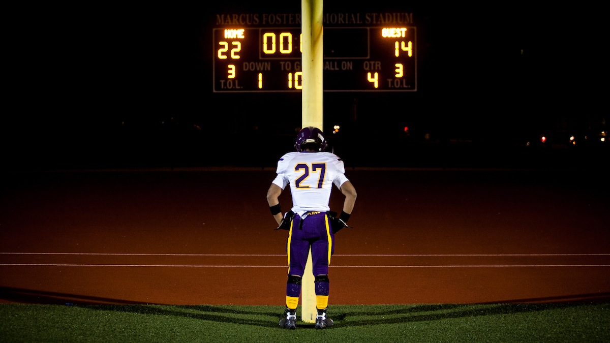 Mooktar Larke of the Cougars rested his head on the field goal post after Friday's season ending playoff loss to Simon Gratz high School. (Brad Larrison/for NewsWorks)