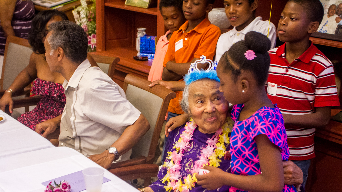 A proud great grandmother gives her great granddaughter a hug. (Brad Larrison/for NewsWorks)