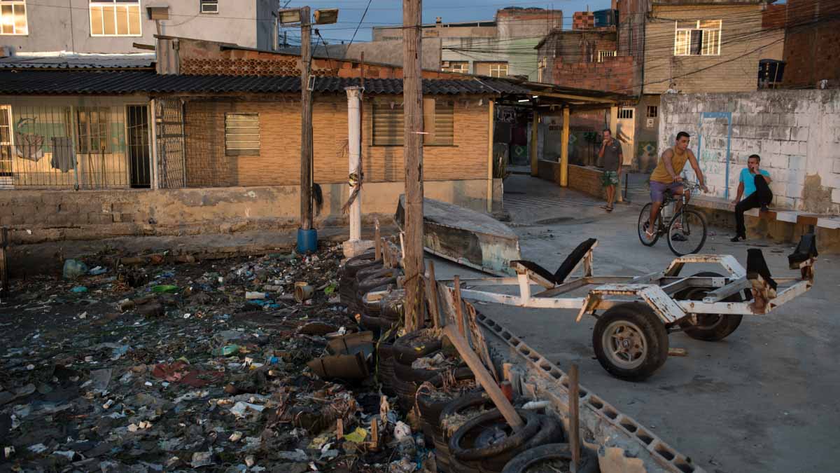 Houses stand next to the heavily polluted shore of Guanabara Bay in Rio de Janeiro