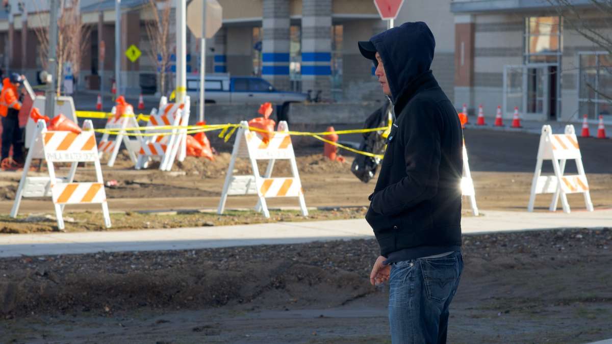  Hair Buzz owner Andy Kim watches PWD work at the site of the water-main break. (Bas Slabbers/for NewsWorks) 
