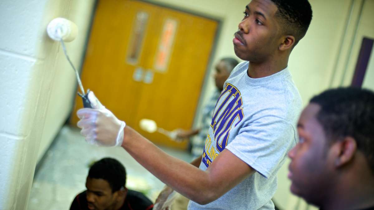  Volunteers painting the walls at MLK High School during the 2014 MLK Day of Service. (Bas Slabbers/for NewsWorks) 