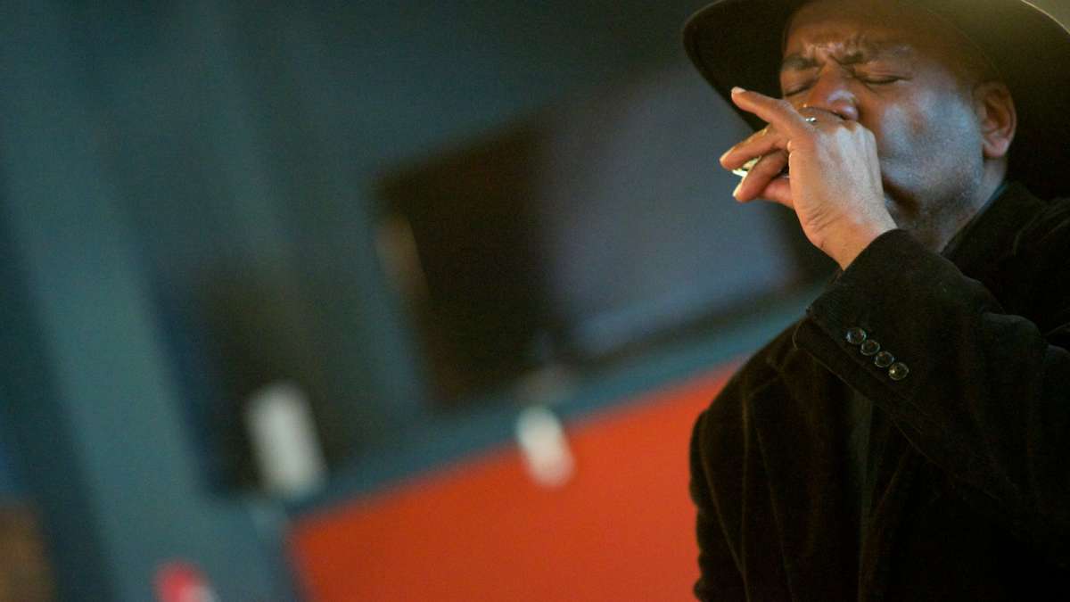  John Colgan-Davis of the Dukes of Destiny captivates the crowd with his harmonica. (Bas Slabbers/for NewsWorks) 