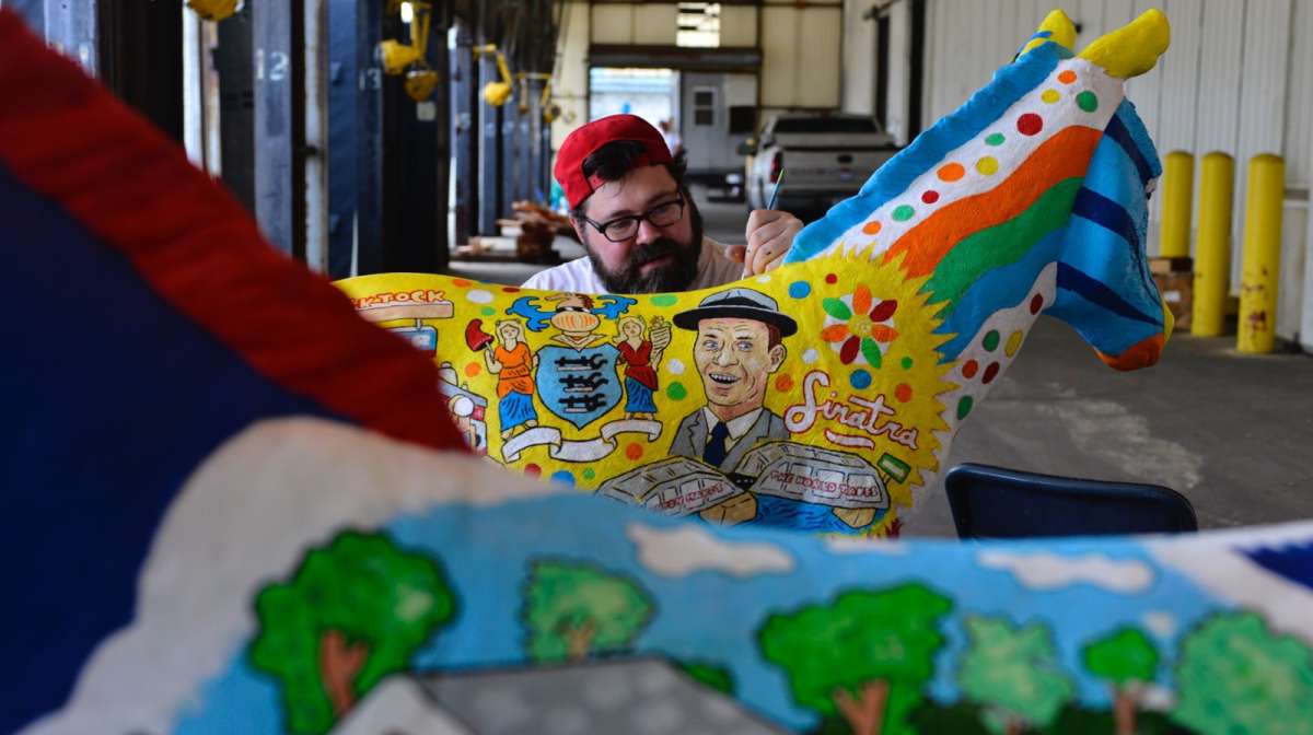 Hawk Krall works on painting New Jersey and New Hampshire DNC donkeys. Many artists are upset that the donkeys were given away