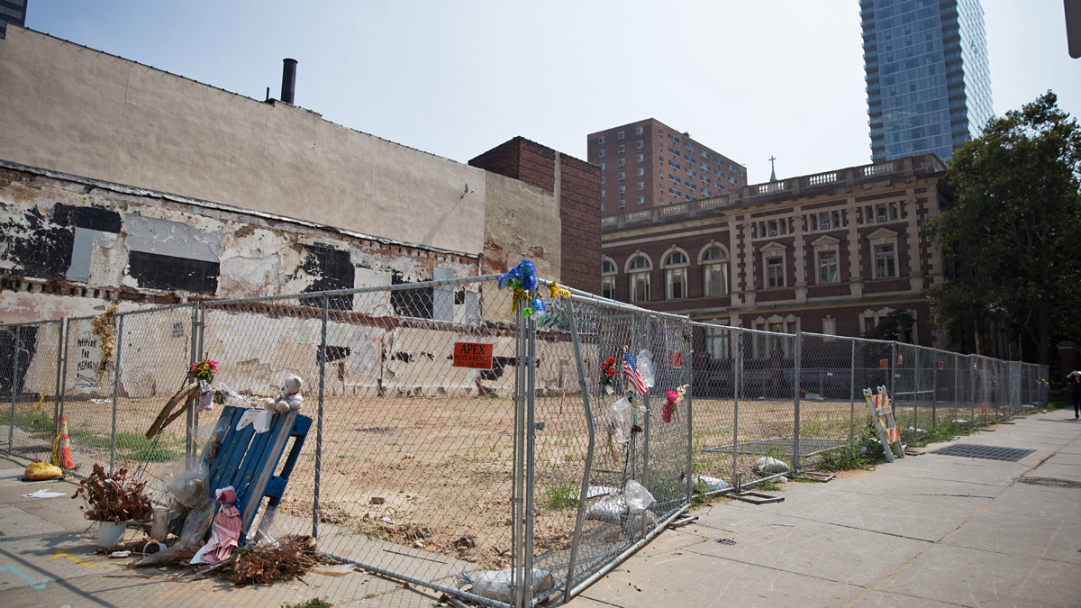  Make-shift memorials and an empty lot mark the site of the four-story building collapse on 22nd and Market Streets in Philadelphia.  (Lindsay Lazarski/WHYY)   