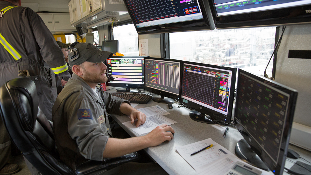 A worker monitors pressurized testing at a Cabot Oil & Gas fracking site in Harford Township