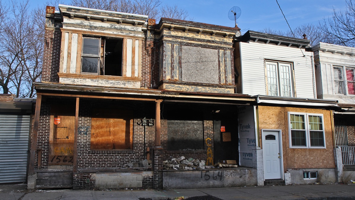 Abandoned homes in poor condition in Camden's Whitman Park neighborhood pose a hazard to residents. (Kimberly Paynter/WHYY)