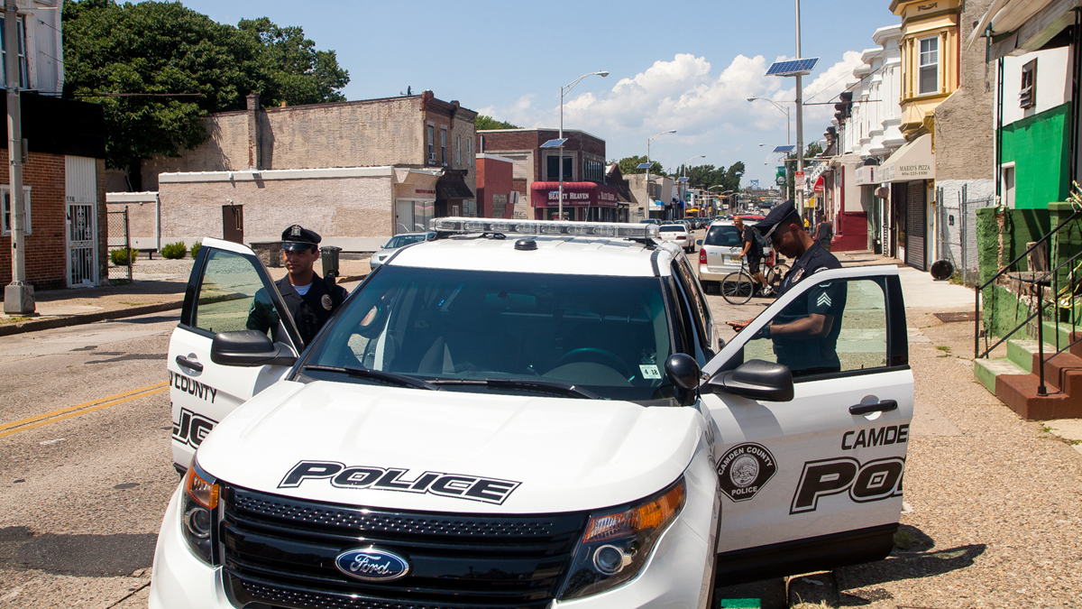  Officers from Camden County's police force enter their vehicle. (Brad Larrison/for NewsWorks) 